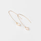 Rana Pearl Threader Earrings in 14k Gold Filled feature a freshwater pearl wrapped in gold wire with tiny hammered detail.