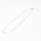Victoria Rice Pearl Necklace in 14k gold filled featuring  trios of freshwater rice pearls in five stations on a white background.