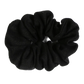 A handmade black linen scrunchie on a white background.