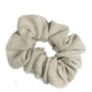 A natural linen scrunchie displayed on a white background.