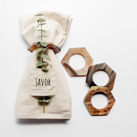 Decorative napkin ring set with a 'Savor' label on a white background