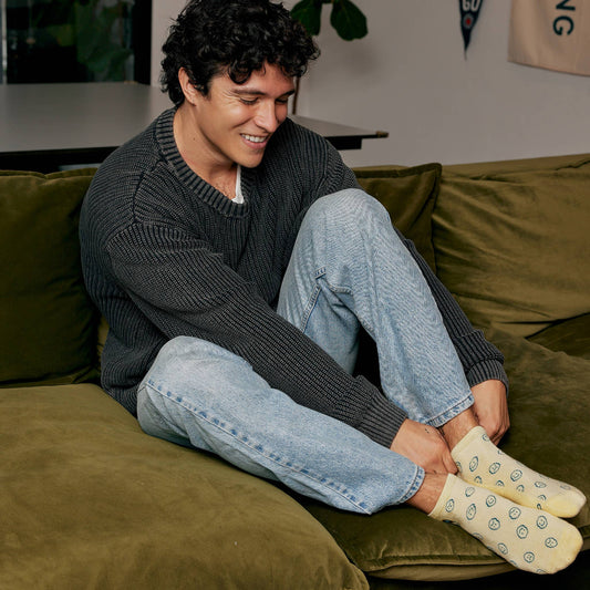 Yellow socks with smiley face patterns on a white background