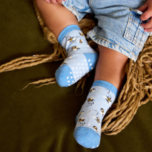 Pair of blue socks with bee pattern on a white background