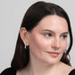 Woman in a black top wearing Amazonite J Hoop Earrings in Sterling Silver