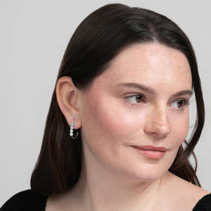 Woman in a black top wearing Amazonite J Hoop Earrings in Sterling Silver. Minimalist.