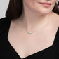 Woman in black wearing a delicate 14k gold filled necklace with four amazonite gemstone beads.