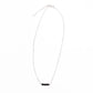 Sterling silver minimalist necklace with black onyx beads on a white background