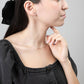 Sideview of woman in black denim dress wearing Esther Chevron Pendant Necklace in Sterling Silver