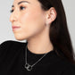 A young woman wearing Zomi Open Circle Earrings and Zomi Circles of Unity Necklace in sterling silver.