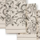 A set of cream-colored fabric napkins with a gray botanical and floral pattern, arranged overlapping on a white background.