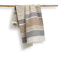 Striped towel hanging on a bamboo rod against a white background