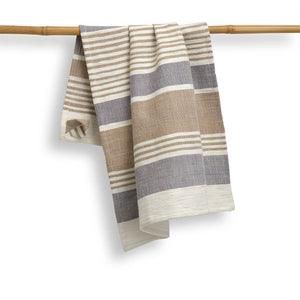 Striped towel hanging on a bamboo rod against a white background