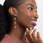 Woman wearing Leeda Freshwater Pearl Triple Drop Leverback Earrings in 14k gold Filled.