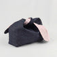a denim and pink gingham makeup bag with a tie closure on a white background