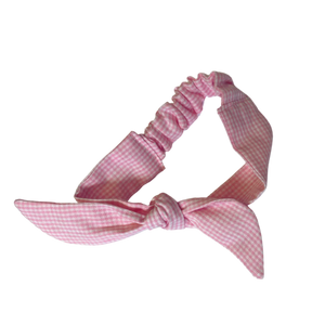 Pink gingham checkered tie headband for kids on a white background
