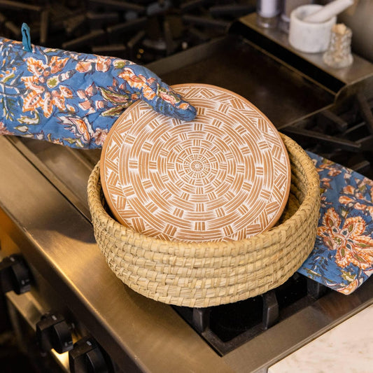 Floral-patterned oven mitt on a marble surface