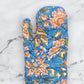 Floral-patterned oven mitt on a marble surface