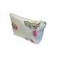 White Jaipur block print zipper pouch with pink pom-pom flowers on a white background and a pink pom-pom zipper tassel 