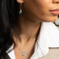 Sideview of woman in white blouse wearing the classic Aqua Chalcedony Hoop Earrings in Sterling Silver 