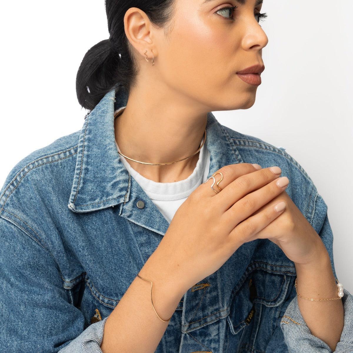 Woman in denim jacket wearing Lana Hammered Brass Collar Necklace - Forai