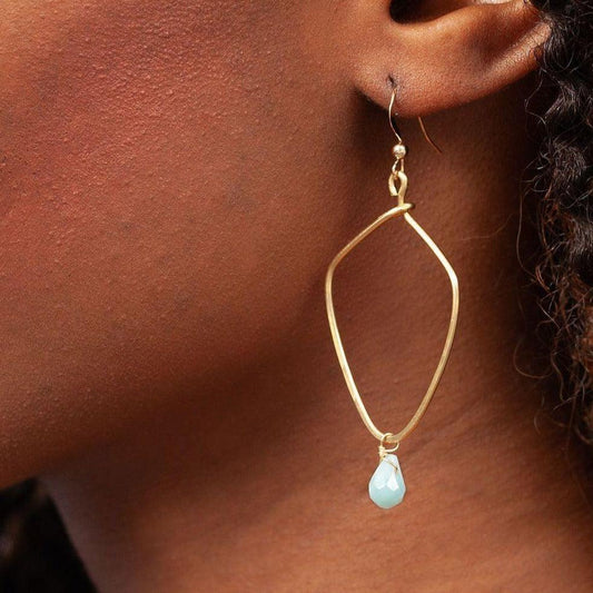 Closeup of woman's ear with Kayah Li Hammered Brass and Amazonite Earrings - Forai