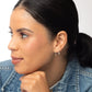 Woman in denim wearing Indra Staple Threader Earrings in Sterling Silver 