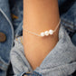 Closeup of arm in denim jacket wearing the Leeda Freshwater Pearl Bracelet in Sterling Silver 