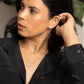 A young woman in a black blouse wearing the Zomi Circles of Unity Necklace and Earrings in Sterling Silver.