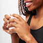 Woman wearing Hand-Hammered Wrap Ring in Brass holding a white cup