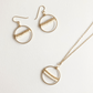 Samira Seeds of Hope Earrings and Necklace in 14k Gold Filled featuring brass circles with white and gold seeds beads across the center.